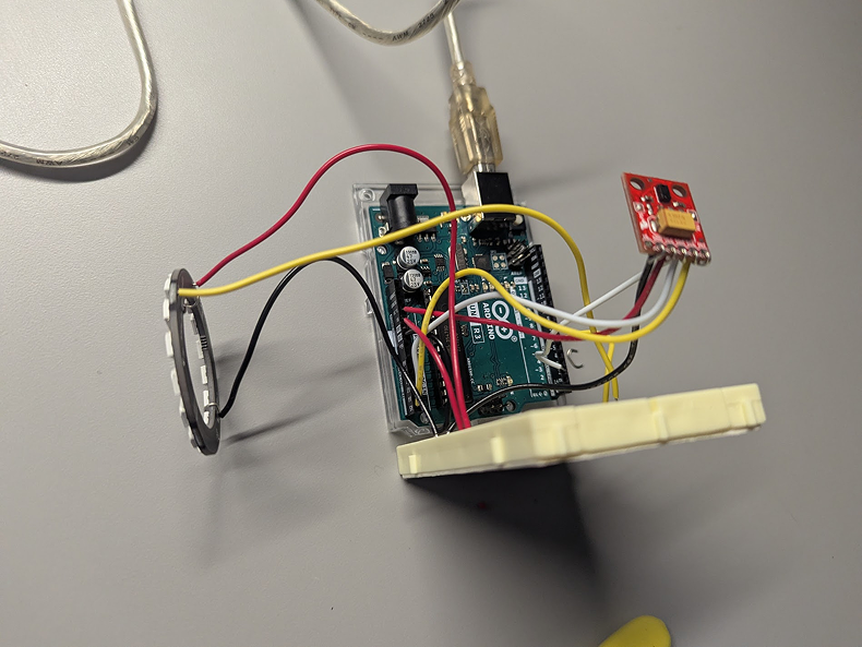 Photo of the neoPixel and APDS 9960 sensor connected to the Arduino Uno via crimped wires. By crimping the wires, I could better position the rings and sensor for when I go about building the object. It was important to be carful however, as using too much force can leave the wires brittle