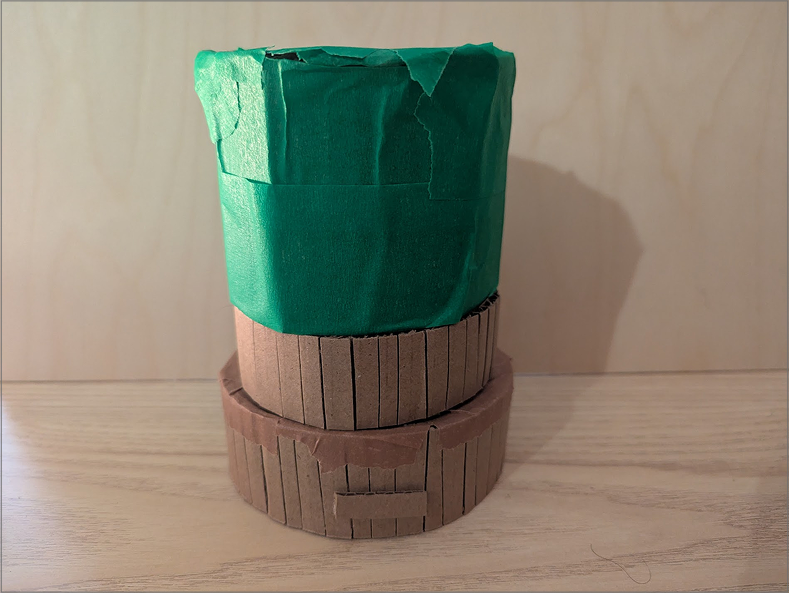 Photo of an alt lamp prototype. While developing the prototype, I wondered what it could be like to include a dial of some kind. Here, I simply test how it could appear if I wanted it fully integrated into the design. The middle ring would rotate around, adjusting an aspect of the lamp.